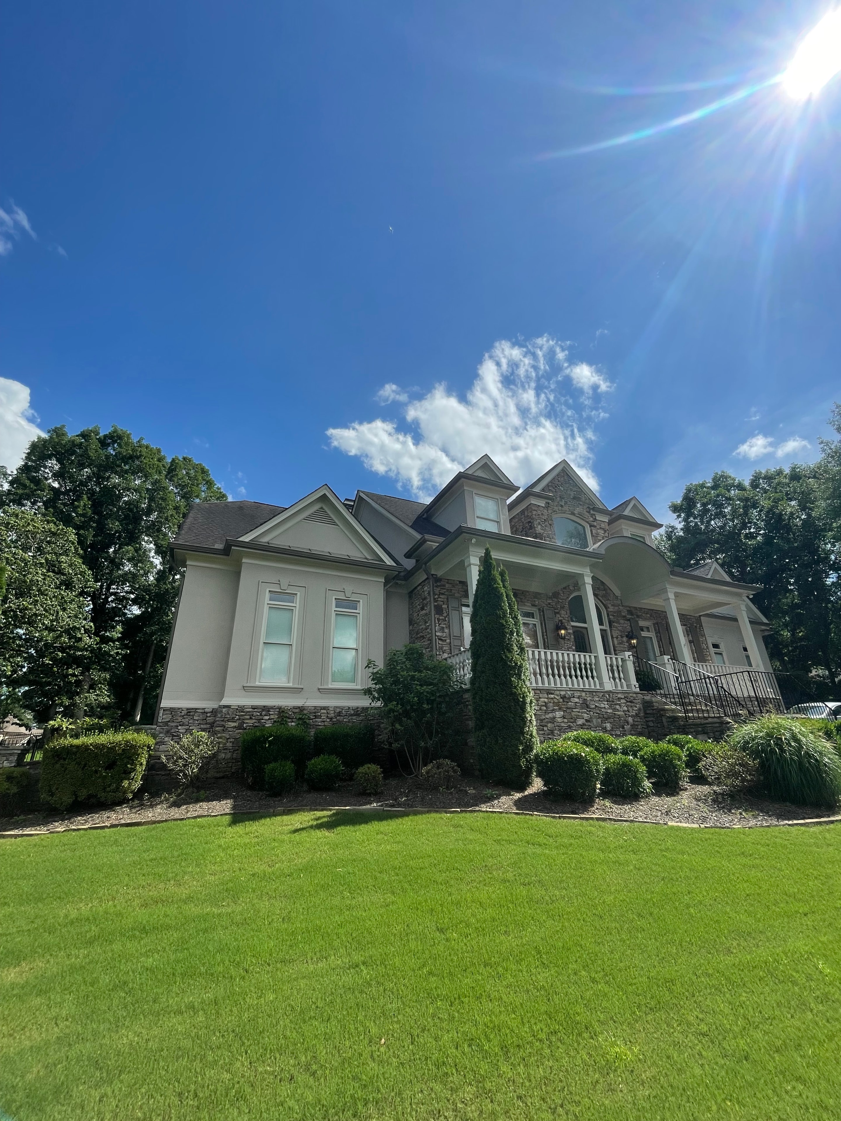 Home exterior with stone accents and painted siding