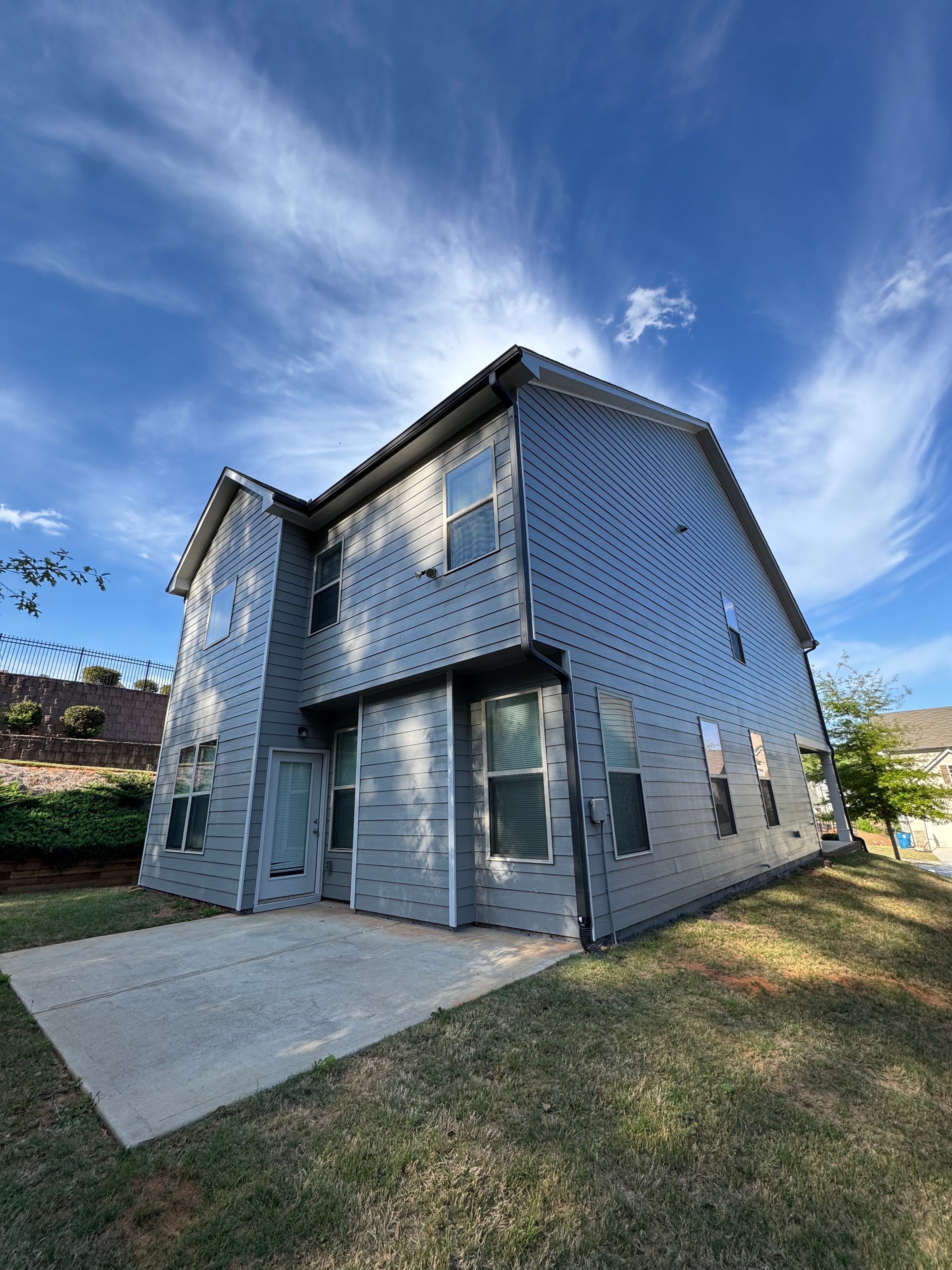 Two story home with charcoal gray painted siding