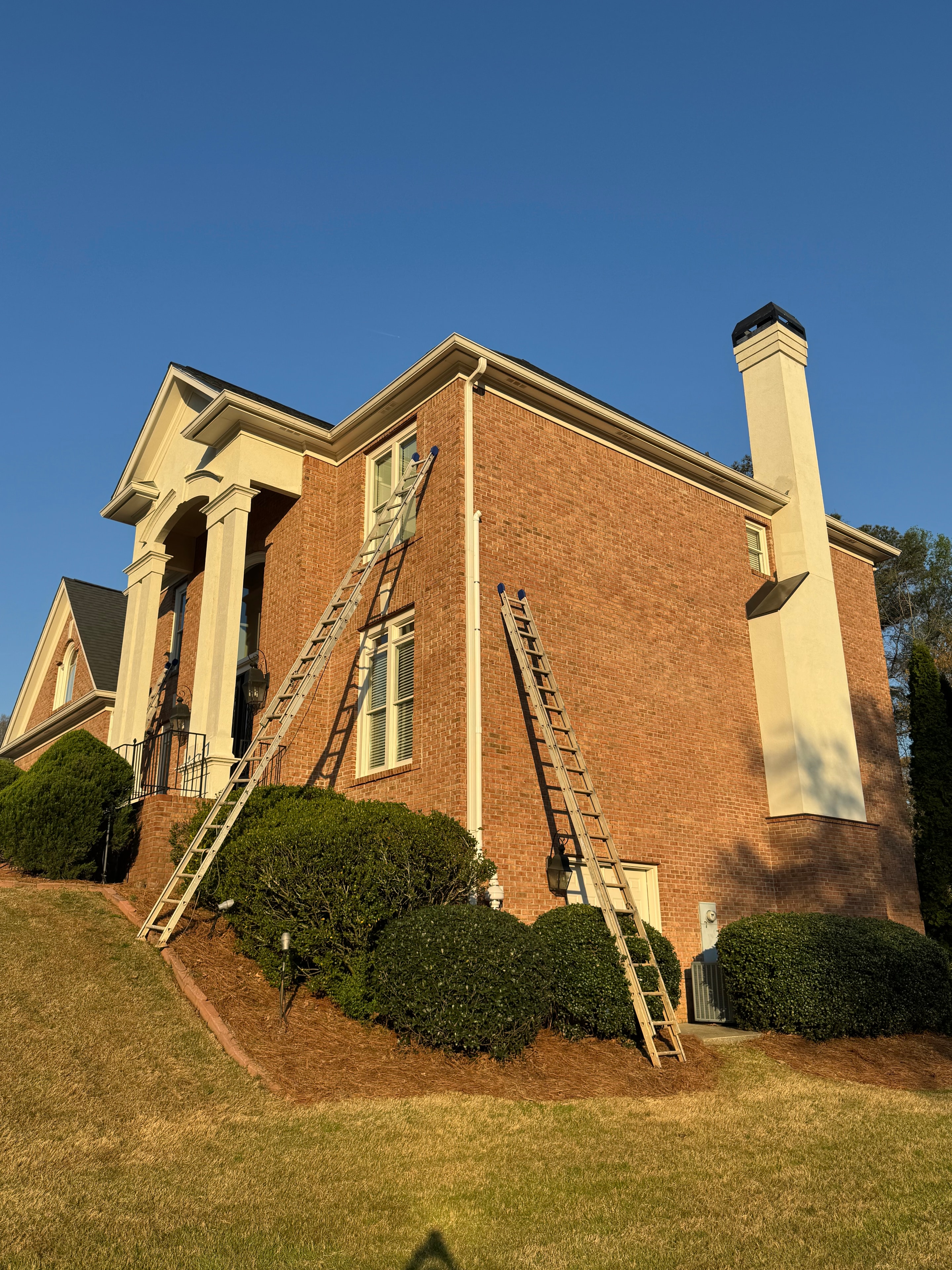 Brick home exterior with painted cream trim