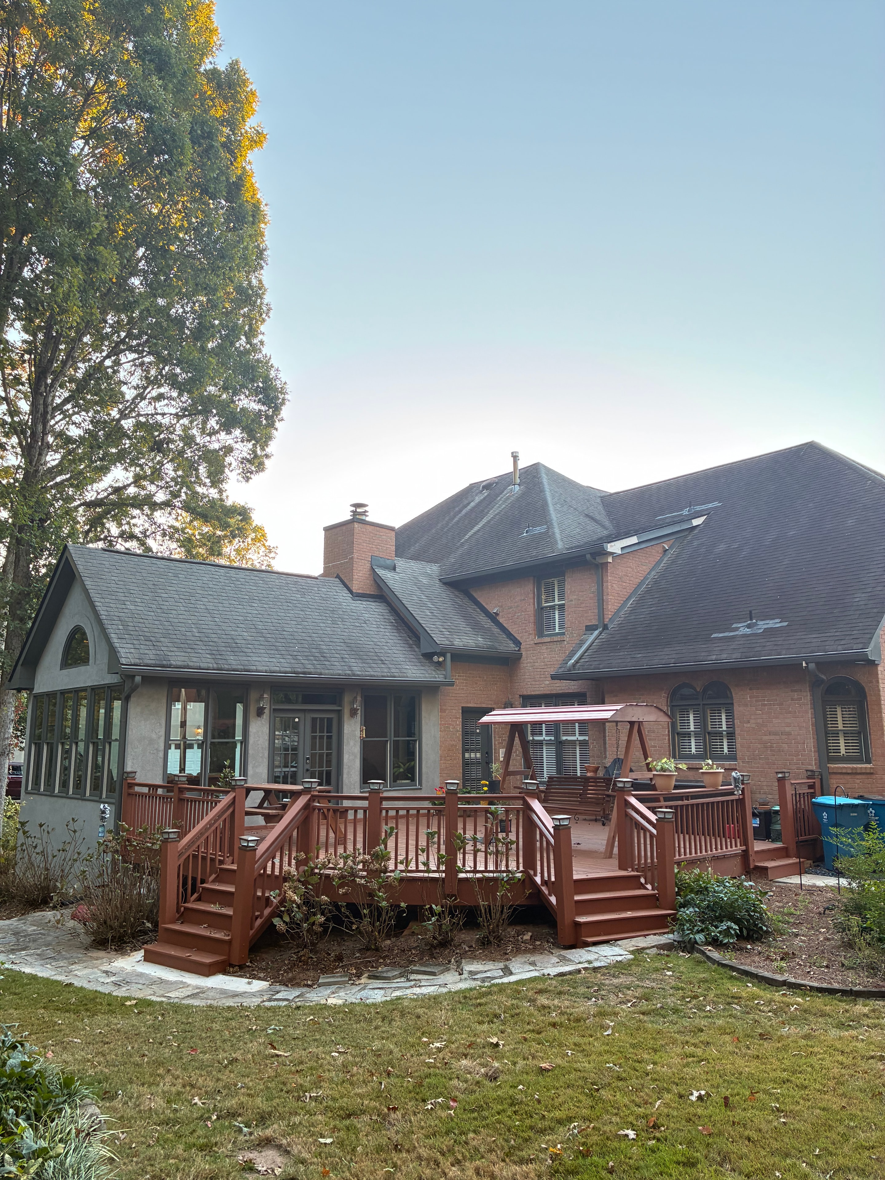 Brick home exterior with painted deck and trim