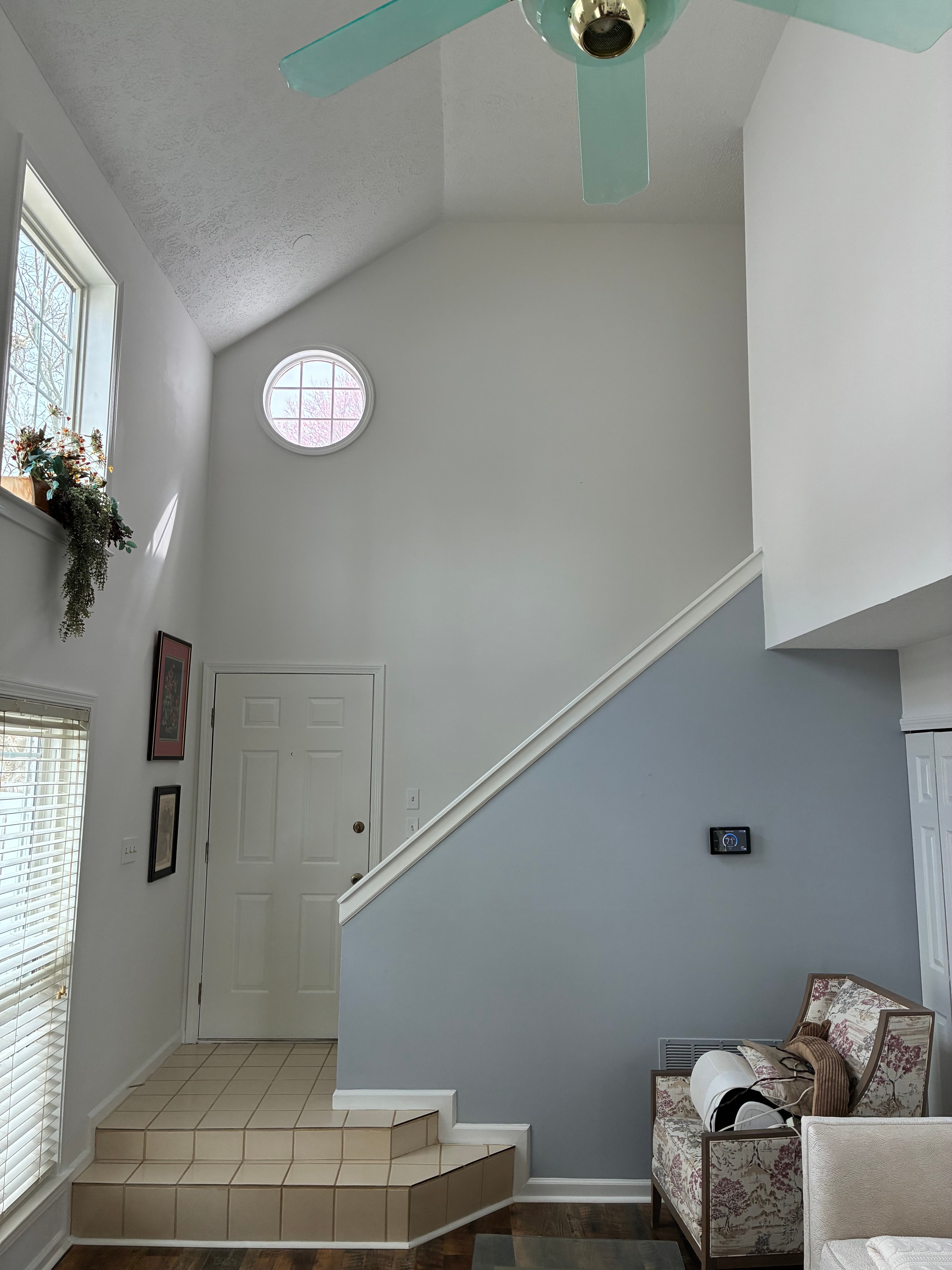Living room with blue and white painted walls and vaulted ceiling