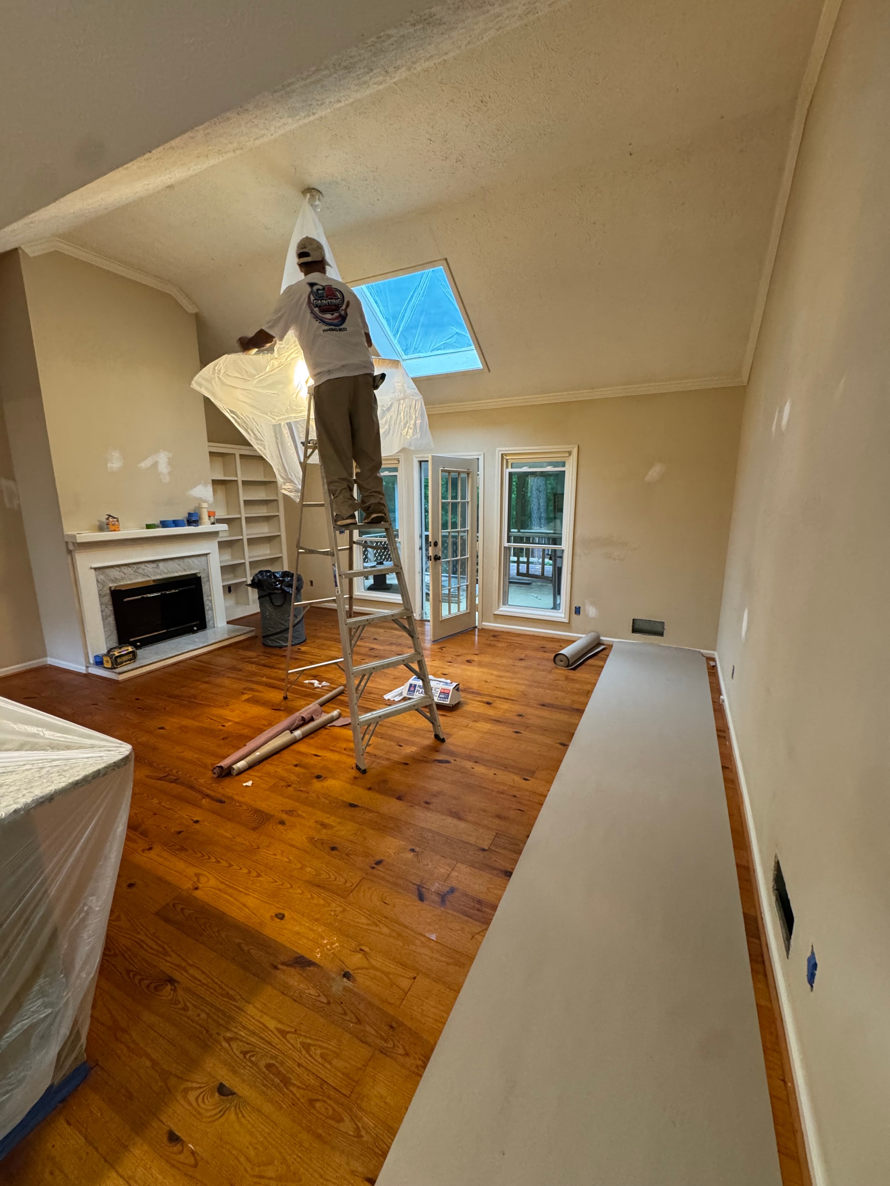 Painter working on interior room repaint