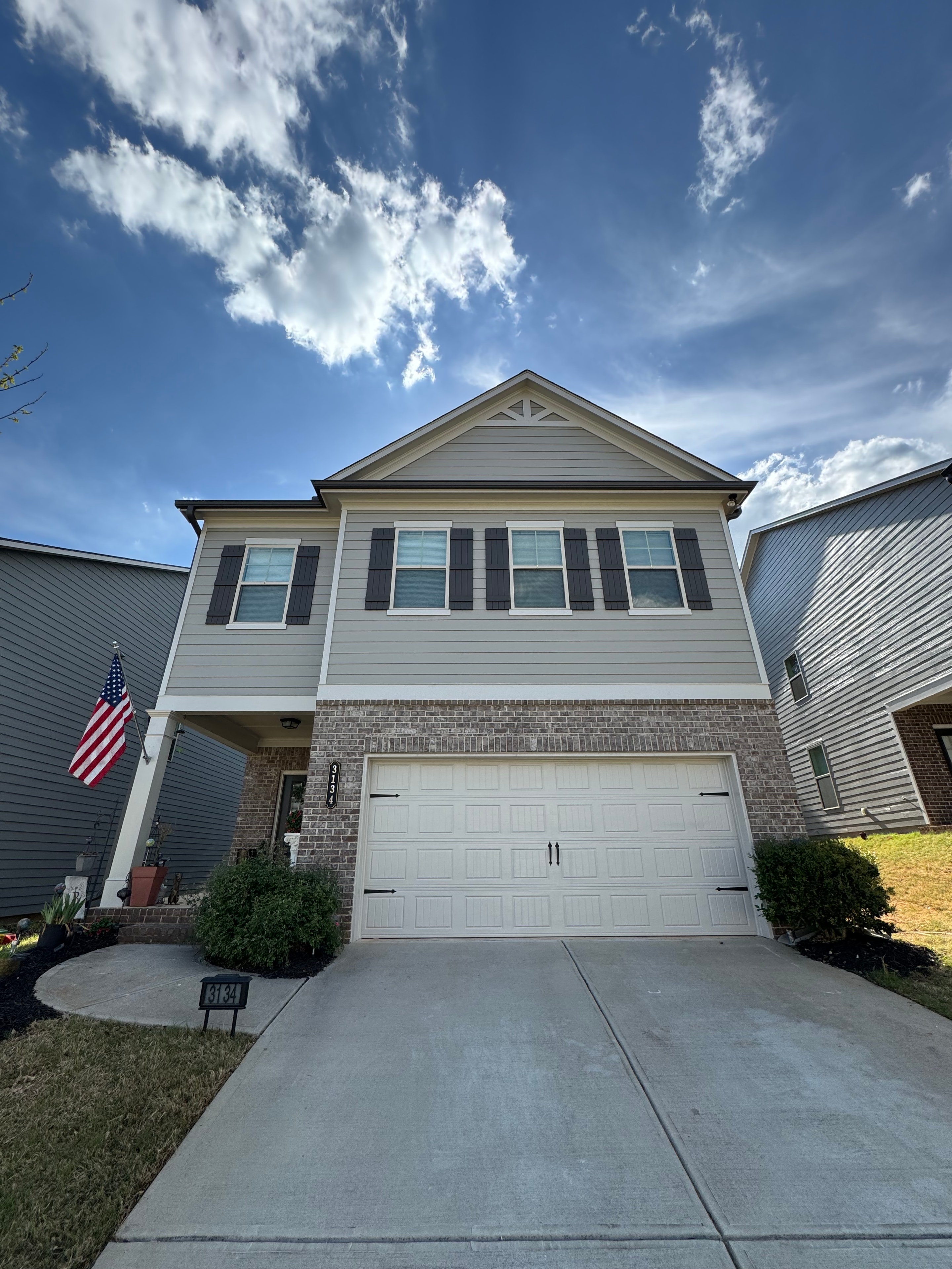 Professional painter working on home exterior